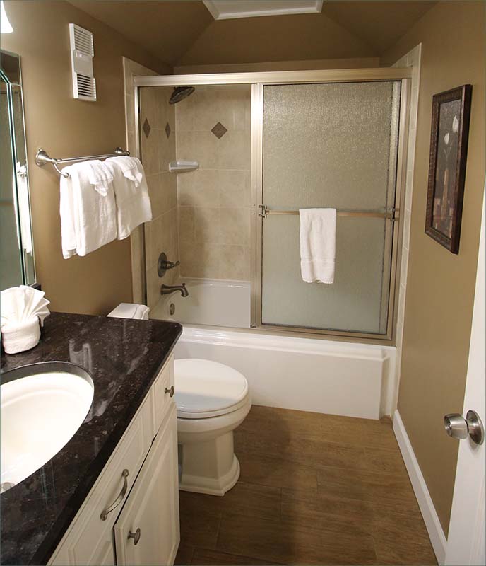Bathroom with sink and tub with shower .