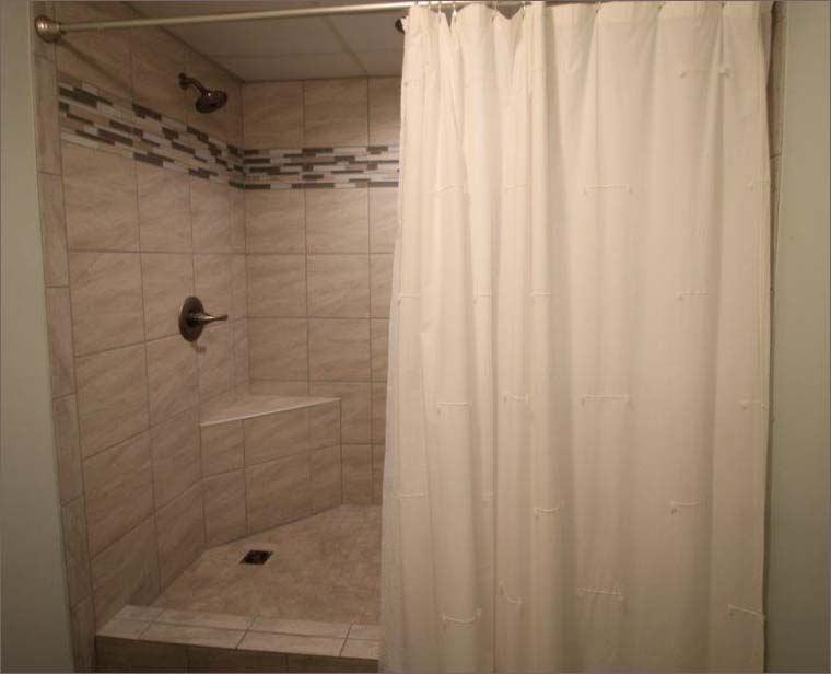 Step in tiled shower with seating.