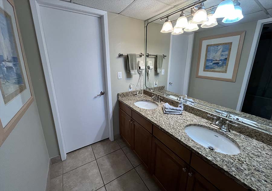 Master bedroom features an en-suite bathroom with twin sinks and countertops.