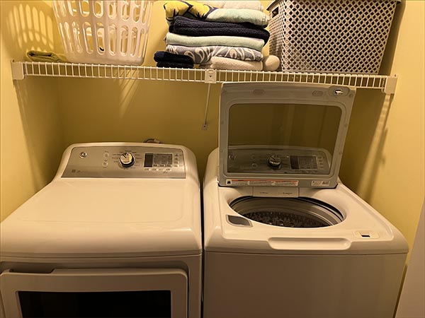 Laundry room includes a full sized washer and dryer.