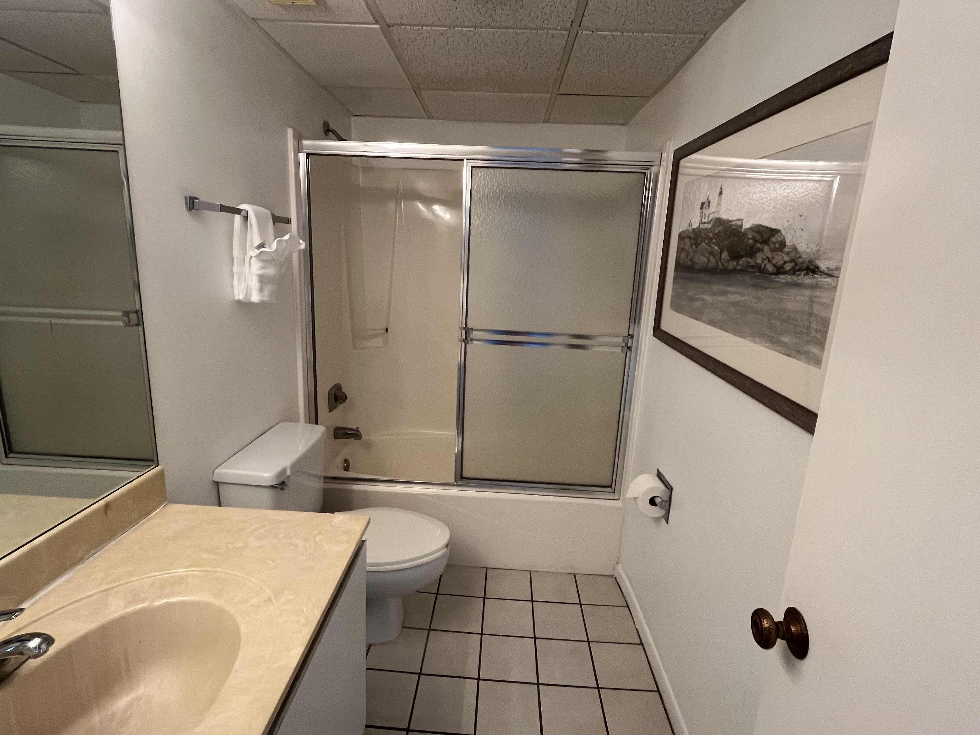 This sunny guest room includes a large, private flat screen TV.