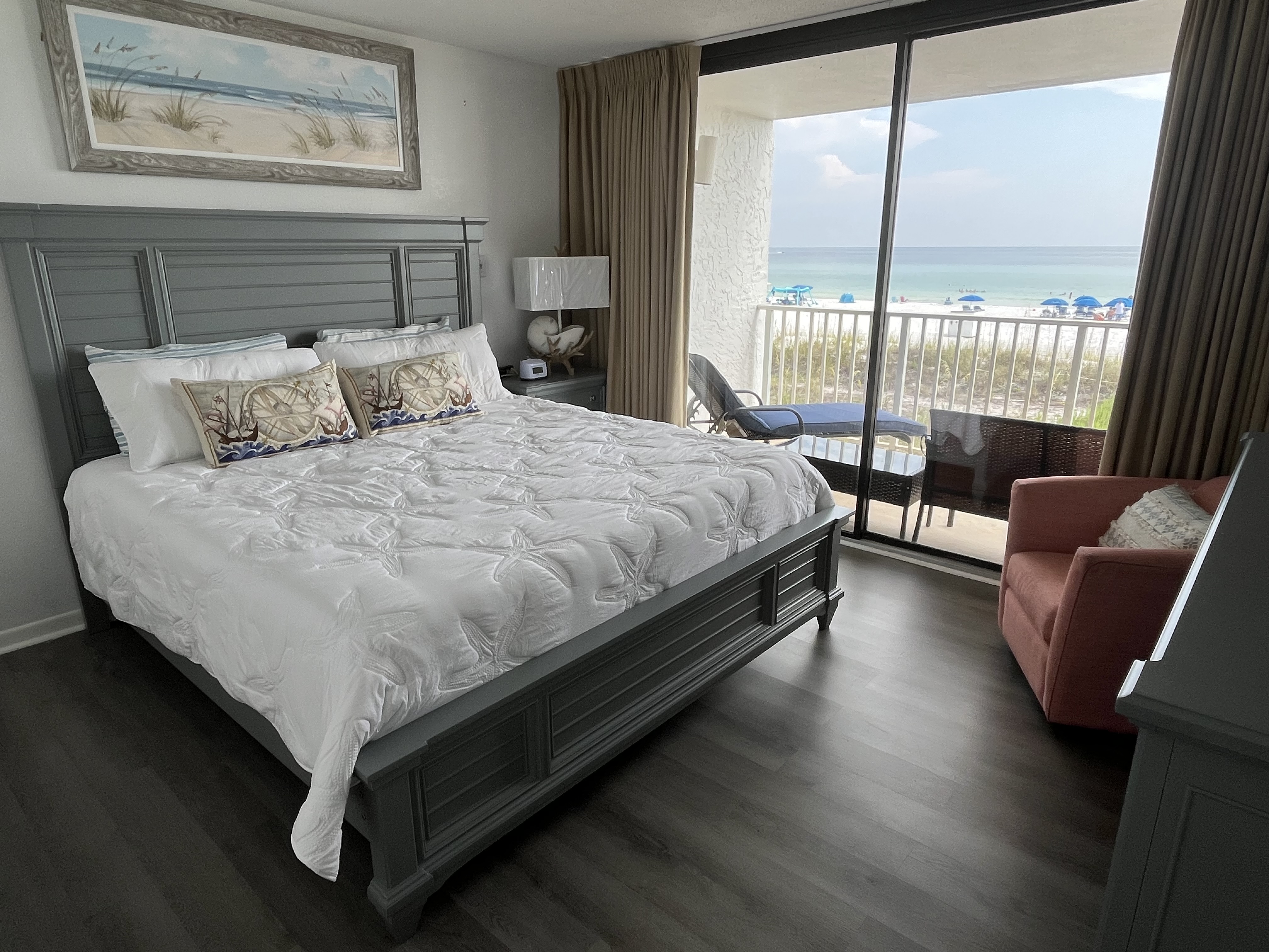 Enormous luxury, king sized bed with beautiful art and decor.