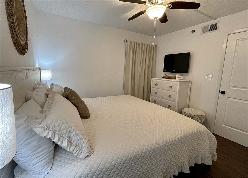 Master bedroom includes a king bed, dresser and large flatscreen TV