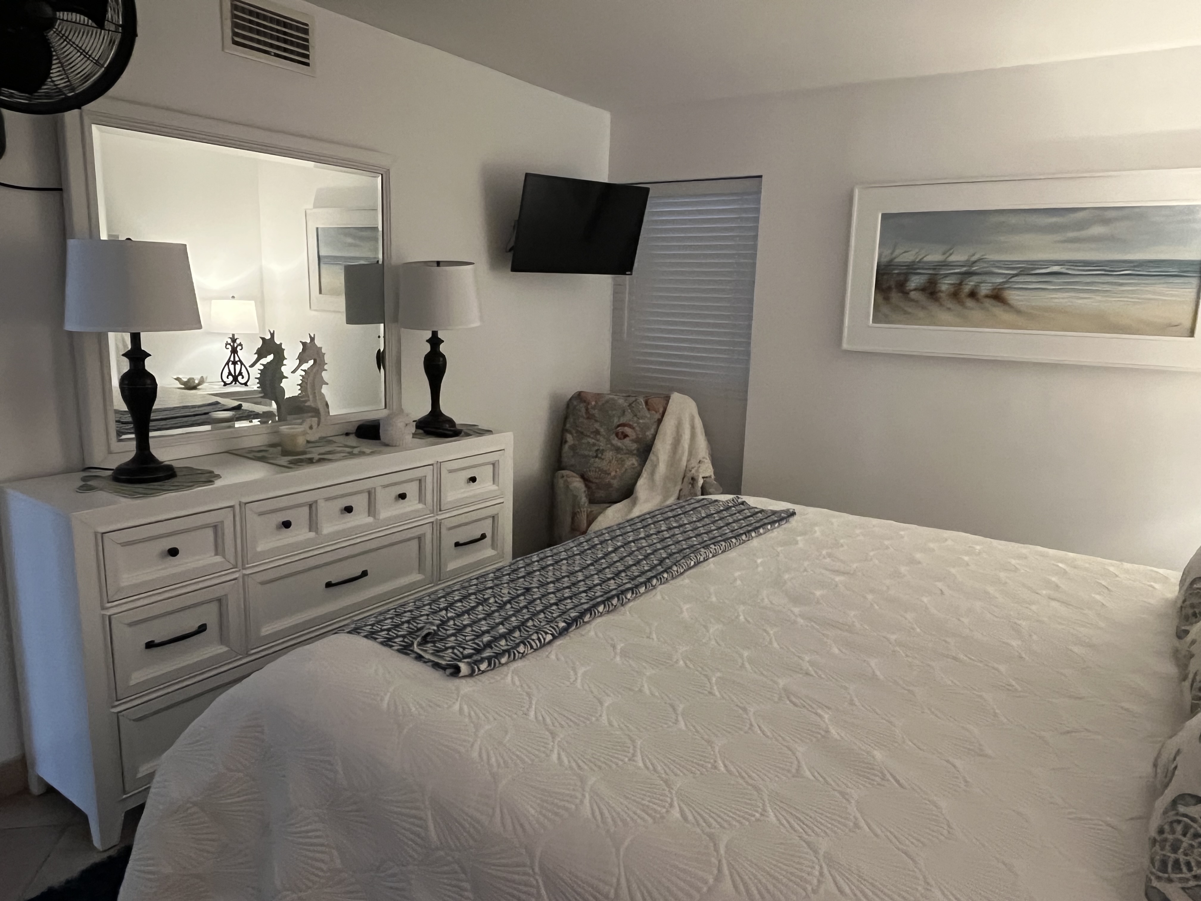 Large private suite with king bed, person flatscreen, comfortable seating and en-suite bathroom. 