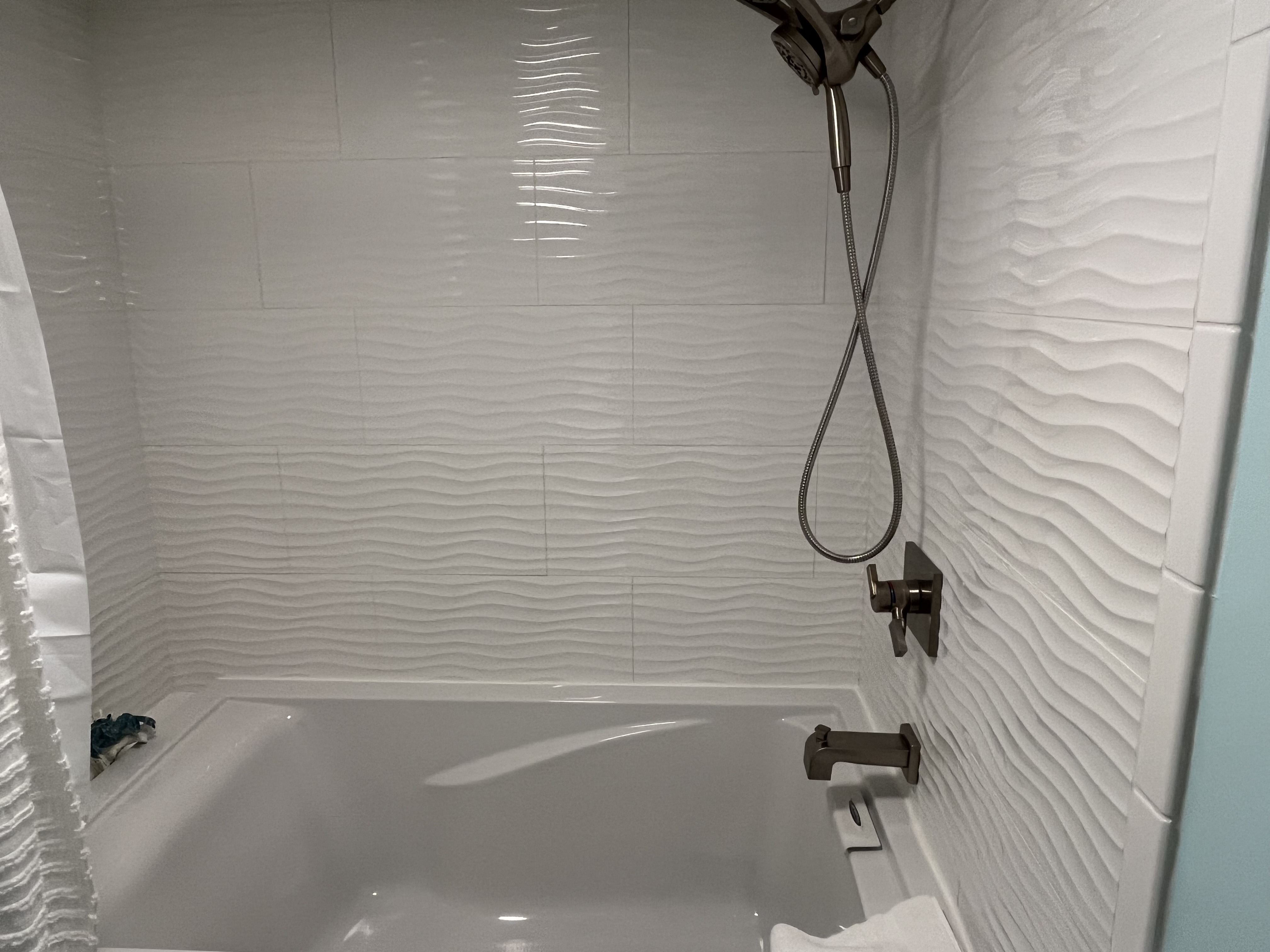 Step in tiled shower with seating.