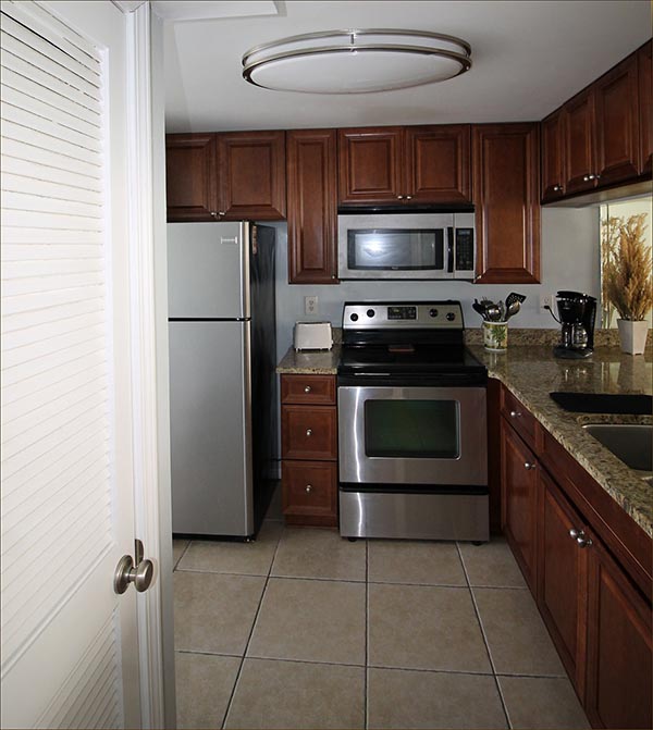 Well appointed luxury kitchen with stainless steel appliances and granite countertops