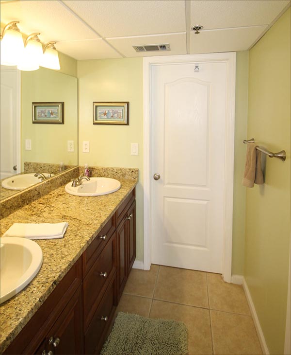 Large private master bathroom with twin vanities and oversized tub and shower.