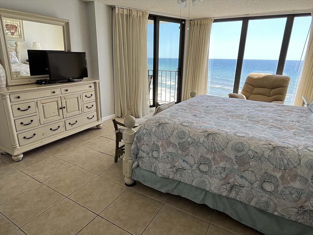 Master bedroom with a wall of windows, private balcony overlooking the Gulf of Mexico.