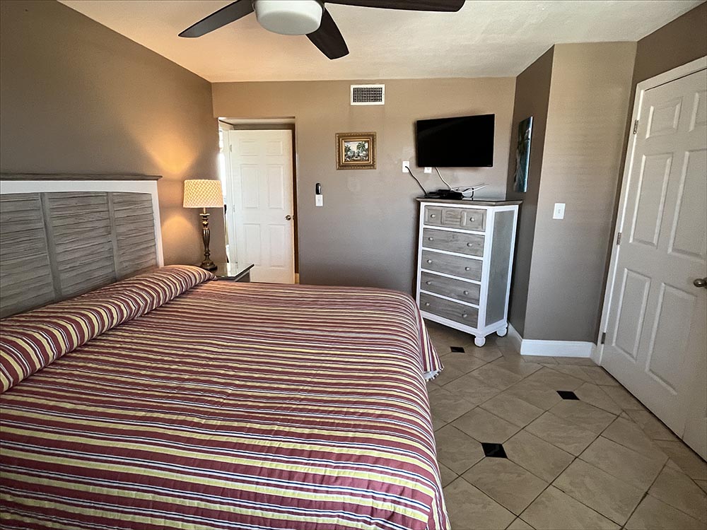 Second master guest suite with king bed, personal TV and attached bathroom.