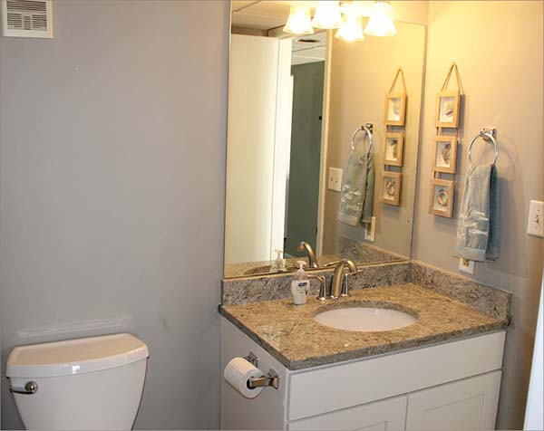 Hallway bathroom with shower and sink also adjoins kitchen, livingroom and guestroom three.