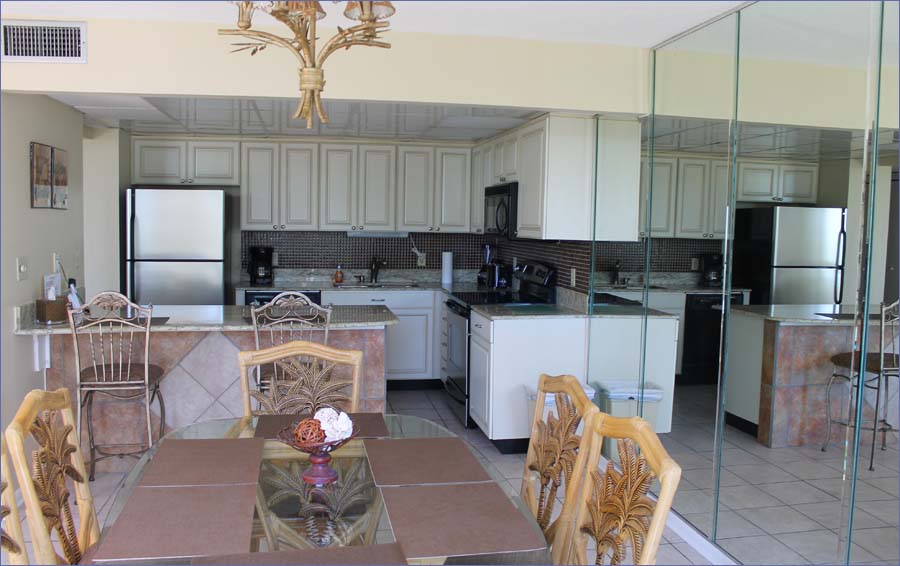 Beach condo includes a dining room area and breakfast bar adjoining the fully equipped kitchen.