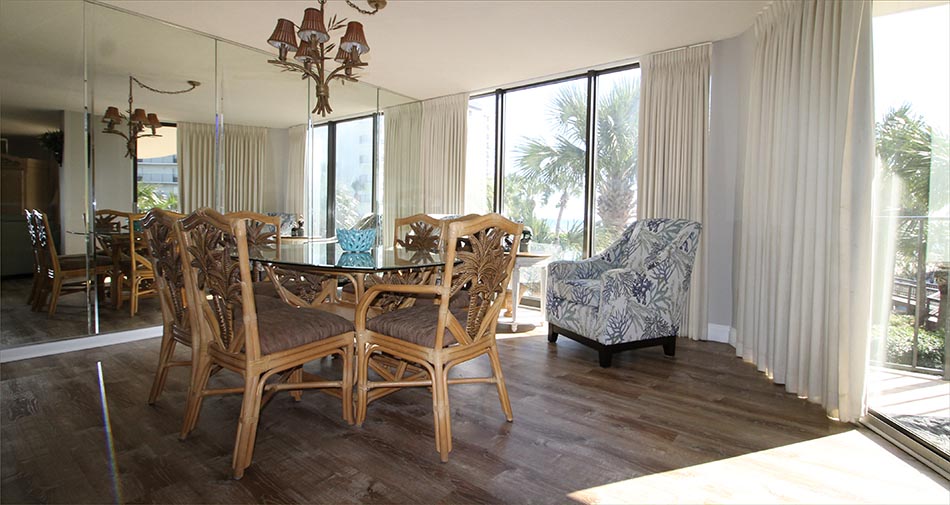 Open dining area with large family seating and indoor outdoor beach condo for rent in Panama City Beach, FL.