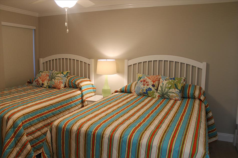Bedroom 3 is furnished with two queen beds.