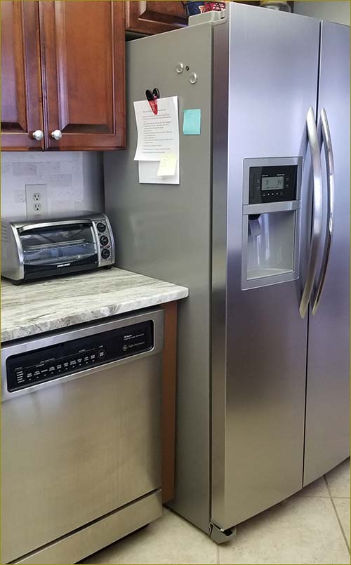 Large stainless steel, side by side fridge with ice maker.