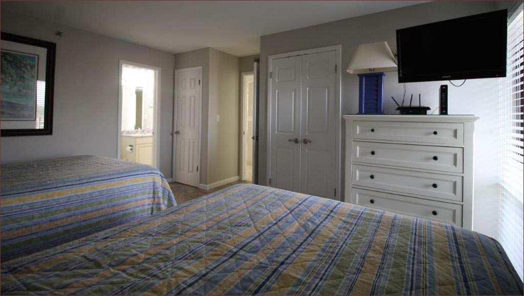 Third bedroom includes 2 queen beds and personal bathroom.