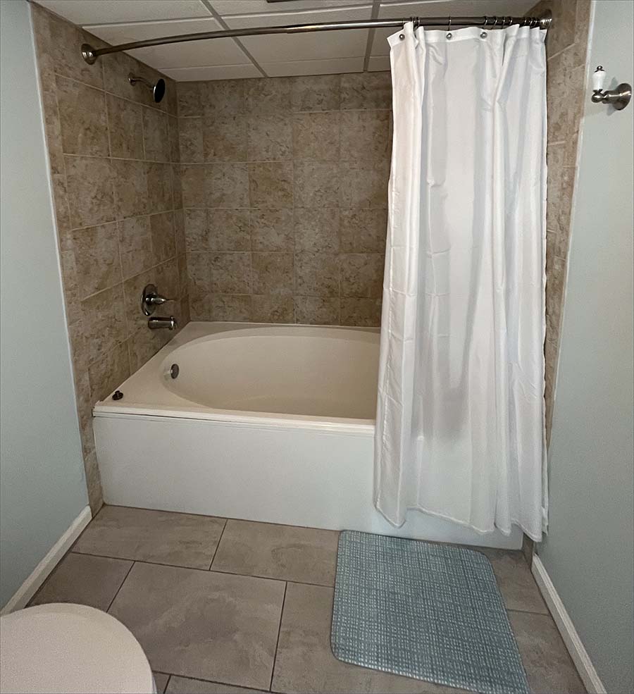 Full master en suite bathroom with tub and shower.